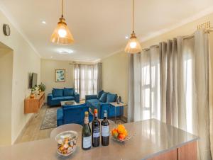 a living room with two bottles of wine on a counter at Oh Wine at Luca's Place in Blantyre