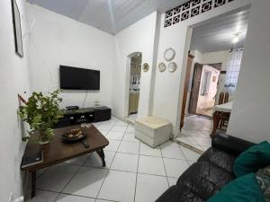 a living room with a couch and a table at Casa Saúde in Salvador