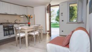 a kitchen and living room with a table and chairs at Agriturismo Le Radici in Borgo Montenero