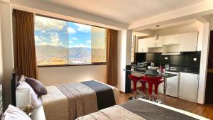 a hotel room with a large window and a kitchen at Allincay Cusco Apart Hotel in Cusco
