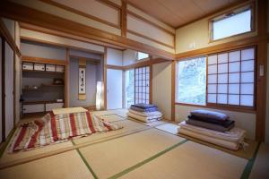 a room with a pile of mats on the floor at Tsushima White House in Tsushima