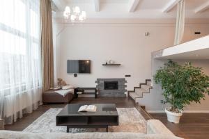 a living room with a couch and a fireplace at Spacious & Cozy loft Near Old Town in Vilnius