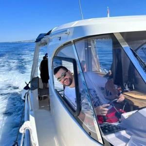 a man sitting in the front seat of a boat at Villa Dalmatina Zadar mit Pool in Zadar