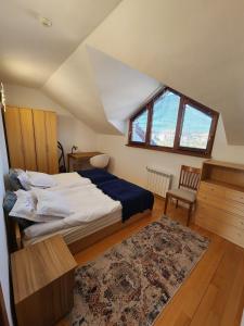 a bedroom with a bed and a desk and a window at One Bedroom Apartment Pirin Lodge in Bansko