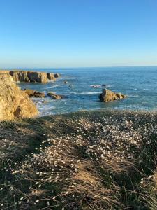 a view of the ocean with rocks in the water at Studio agréable 300m Côte Sauvage in Le Pouliguen