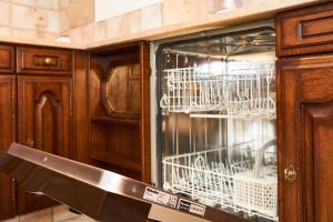 a kitchen with white dishes in a glass cabinet at Supercrans, Rte de la Tour 10, Superb View!! in Crans-Montana