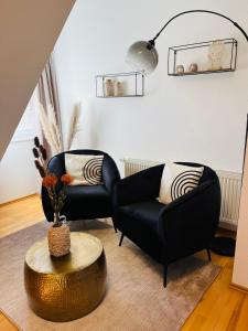 a living room with two chairs and a table at FeWo 1 an der historischen Bahnlinie in Leutkirch im Allgäu