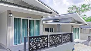 a house with a gate and a balcony at The Engineer's Villas, Krabi in Ban Khlong Chi Lat