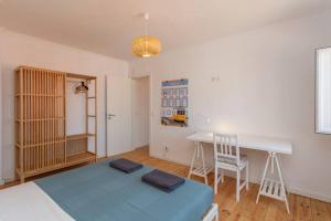 a bedroom with a bed and a table and a desk at Mouraria Lisbon Soul Apartments T1 - 4 pax in Lisbon