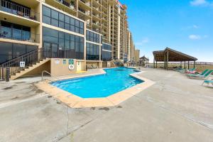 a swimming pool in front of a building at Phoenix 1093 in Orange Beach