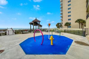 a playground with a fire hydrant on a blue carpet at Phoenix 1093 in Orange Beach
