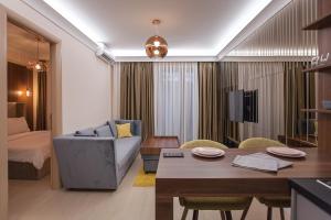 a living room with a couch and a table at GM SkyView Luxury Flatiron apartment Skopje in Skopje