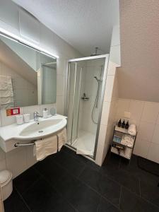 a bathroom with a sink and a shower at Apartment Enzian in Saas-Grund