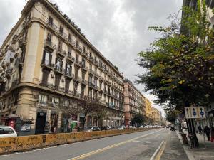 an empty city street with a large building at Casa Imperatore in Naples