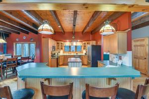 a kitchen with a large blue island in a room at Secluded Adirondack Cabin about 5 Mi to Sacandaga Lake in Broadalbin