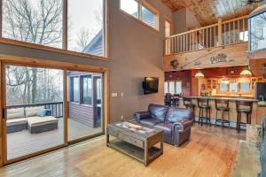 a living room with a couch and a table at Secluded Adirondack Cabin about 5 Mi to Sacandaga Lake in Broadalbin