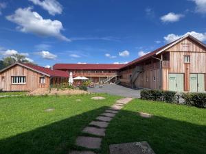 a barn with a grassy yard in front of it at Bike Lodge Spessart in Lohr