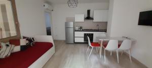 a kitchen and dining room with a table and chairs at Villasimius Appartamento "Il Ginepro" in Villasimius