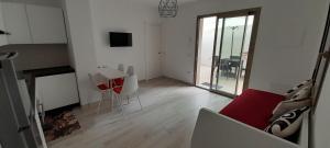 a living room with a red couch and a table at Villasimius Appartamento "Il Ginepro" in Villasimius