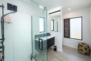 a bathroom with a glass shower and a sink at Vinebox on Wilson in Martinborough  +18 photos