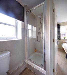 a bathroom with a shower and a toilet at Guildford Townhouse with Parking in Guildford