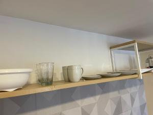 a shelf with bowls and plates on it at Florencia in Termas de Río Hondo