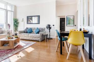a living room with a couch and a table at Elegant apartment in Bordeaux at Les Chartrons in Bordeaux