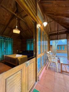 a room with a bed and a table and chairs at Royal Wooden villa in Mananthavady