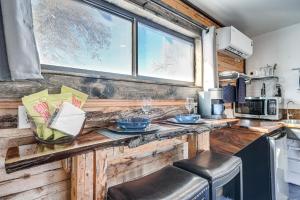 a kitchen with a counter with bowls and dishes on it at Cozy Parowan Studio 12 Mi to Brian Head Resort! in Parowan