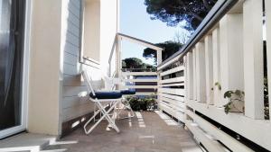 a chair on the porch of a house at Leo's Villa in Milano Marittima