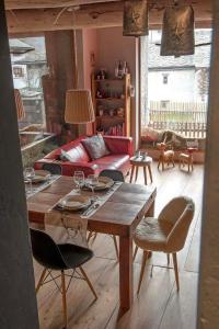 a living room with a table and a couch at La Stalla in Vicosoprano