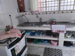 a small kitchen with a sink and a counter top at Casa PARA FINAIS DE SEMANA E TEMPORADA EM UBATUBA in Ubatuba +26 photos
