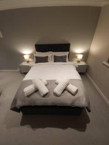 a bedroom with a large white bed with two pillows at Stunning Apartment overlooking Pembroke Castle in Pembroke