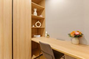 a room with a wooden desk with two chairs at 1BR Luxury apt at prime location w carpark in Brisbane