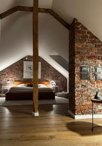 a bedroom with a bed in a brick wall at Schickes Studio in bester Lage in Bad Salzuflen