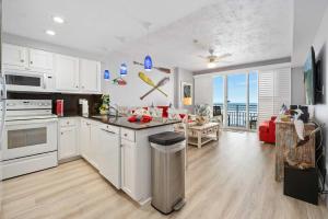 a kitchen with white cabinets and a view of the ocean at Luxury Beach Villa Wyndham Ocean Walk Resort in Daytona Beach