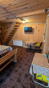 a room with two beds and a tv on the wall at Villa ALVIK in Geoagiu Băi