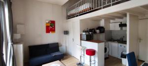 a living room with a couch and a loft bed at Apartment Bordeaux Bègles in Bègles