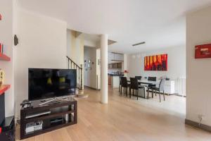 un soggiorno con televisione e una sala da pranzo di Family house Bordeaux a Bordeaux