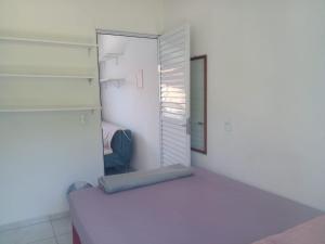 a small bedroom with a bed and a closet at Apartamentos PRAIA DE BOMBAS in Bombinhas