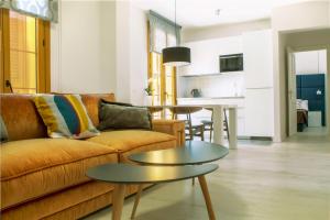 a living room with a couch and a table at Santa Cruz Apartments in Málaga