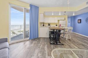 a living room with a kitchen and a table with chairs at Luxury 6th Floor 2 BR Condo Direct Oceanfront Wyndham Ocean Walk Resort Daytona Beach | 601 in Daytona Beach