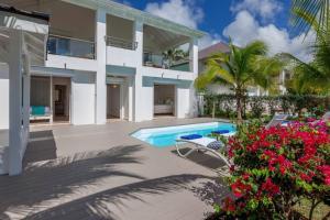 an exterior view of a house with a swimming pool at Seafront sunset & beach access in Saint Martin