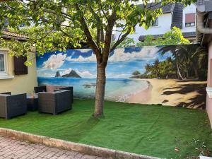 a mural of a beach on the side of a building at Studio indépendant proche Paris in Chennevières-sur-Marne