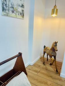 a wooden horse statue sitting on the floor in a room at La Belle Etape à Carcassonne in Carcassonne