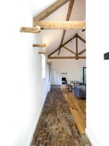 an open living room with exposed beams at Beaumont Mews in St. Albans