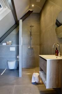 a bathroom with a sink and a toilet in a room at Bedje in de polder in Montfoort