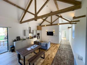 a living room with a table and a couch at Beaumont Mews in Saint Albans