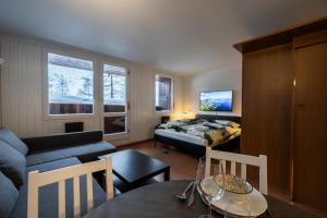 a small living room with a bed and a couch at Erikzang - Cervinia Ski in Ski out Apartments in Breuil-Cervinia