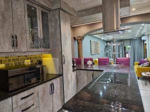 a kitchen with a counter and a dining room at Molozi in Kimberley +7 photos